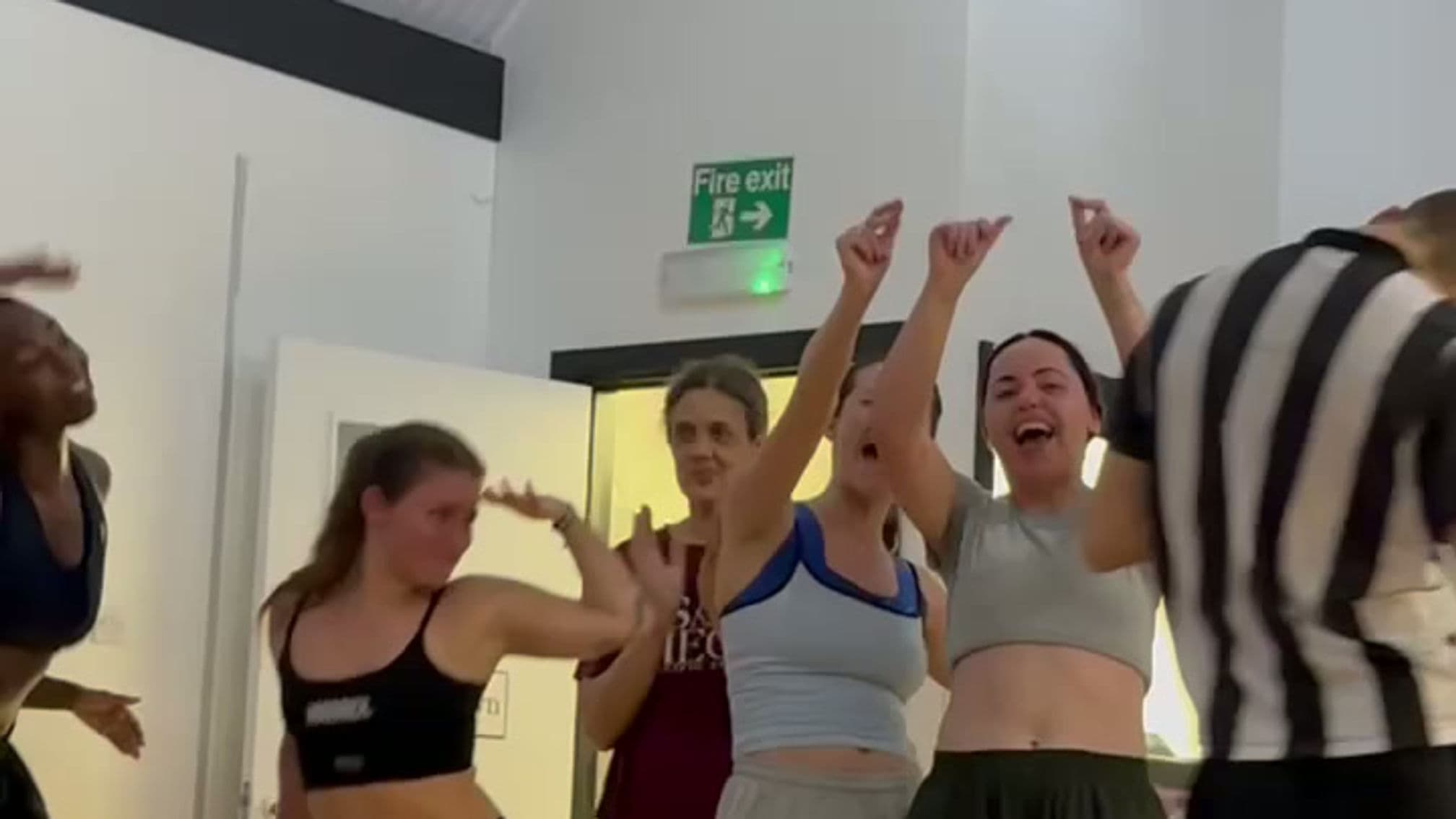 Dancers celebrating together at the end of a class