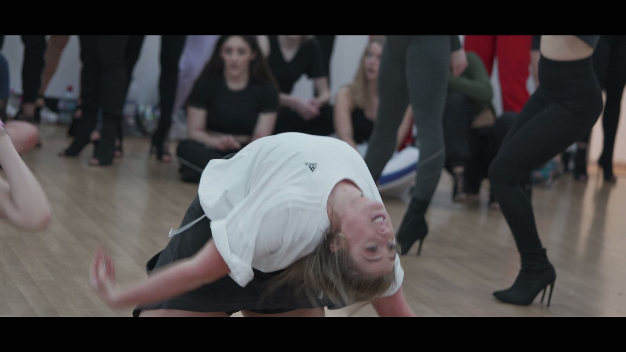 A dancer mid-movement during a class at BASE